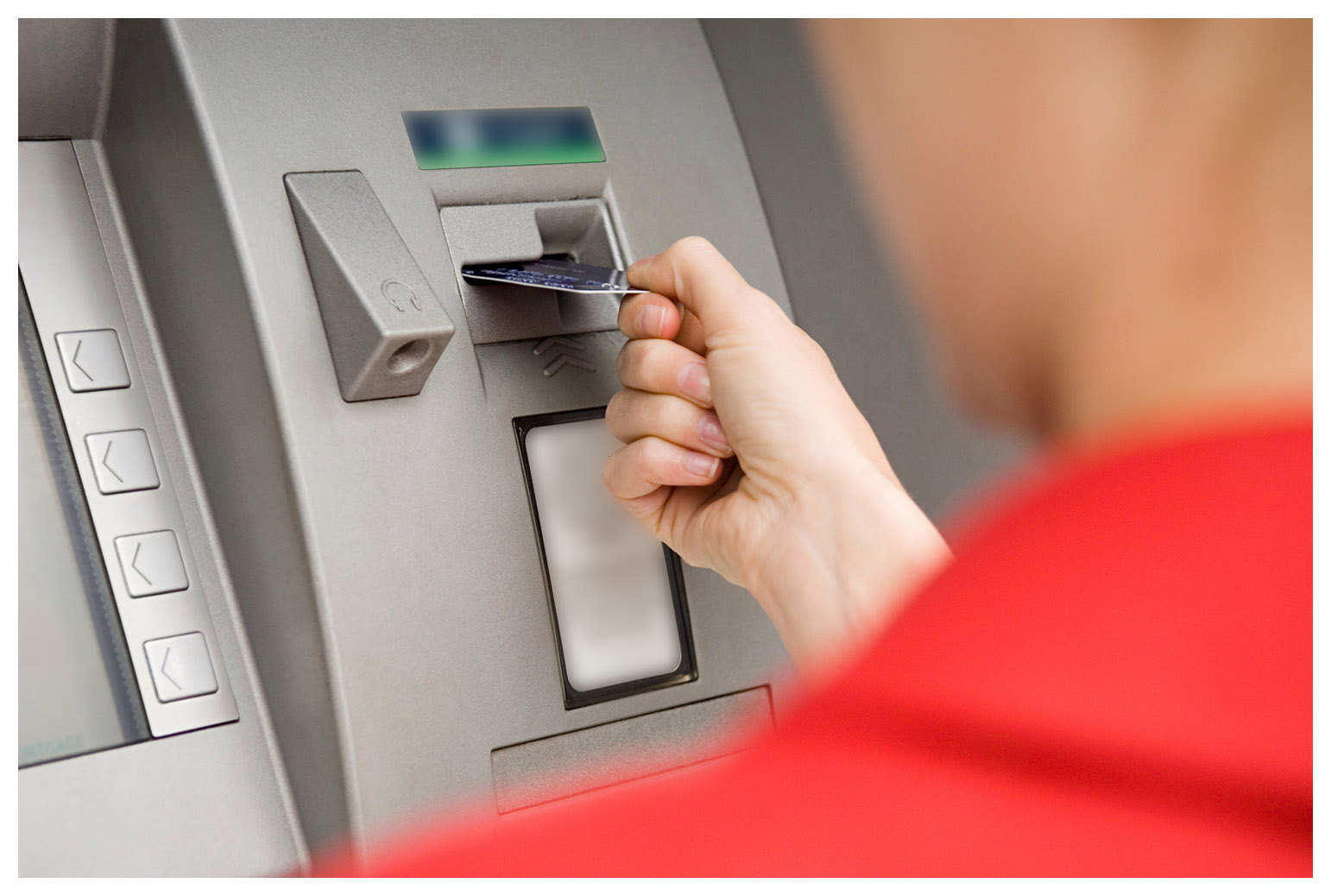 Person using cash machine --- Image by © Image Source/Corbis